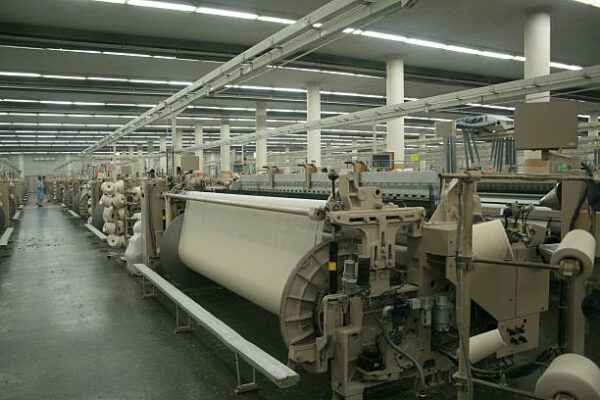 Weaving looms in a textile weaving unit.  *** Machine are operational hence some motion.