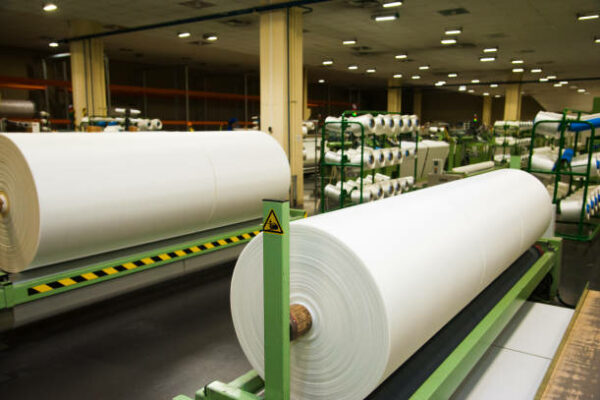 Industrial fabric production line. Weaving looms at a textile factory