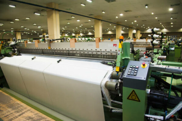 Industrial fabric production line. Weaving looms at a textile factory