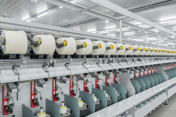 Machinery and equipment in the workshop for the production of thread. interior of industrial textile factory