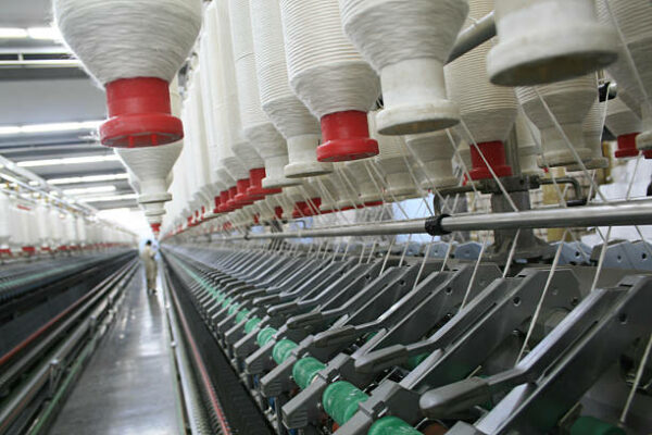 Rieter Spinning machines making thread in Textile Spinning unit.  *** Machine are operational some motion blur visible.