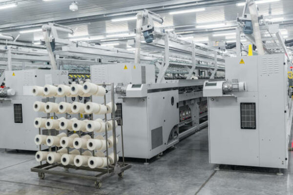 Machinery and equipment in the workshop for the production of thread. interior of industrial textile factory